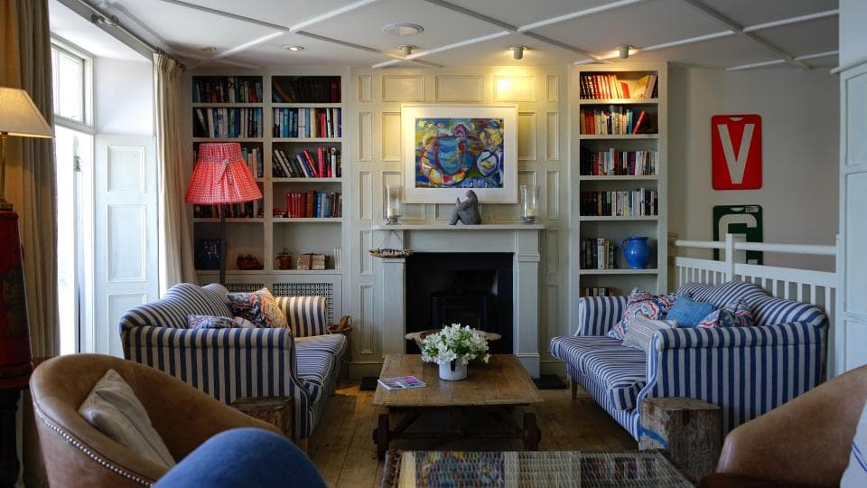 A sitting room with bookshelves either side of a fireplace