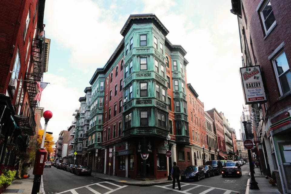Brick apartment buildings with bay windows on a corner street